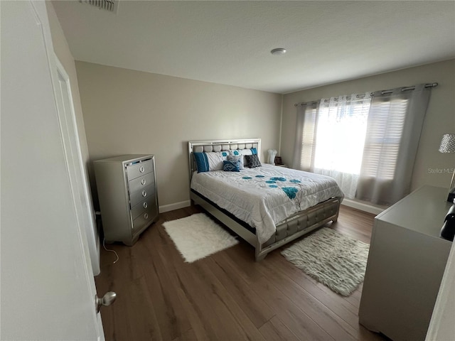 bedroom with hardwood / wood-style floors