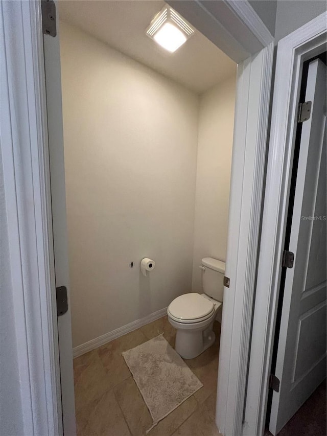 bathroom featuring toilet and tile patterned flooring