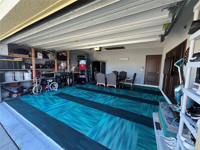 garage with ceiling fan and a garage door opener