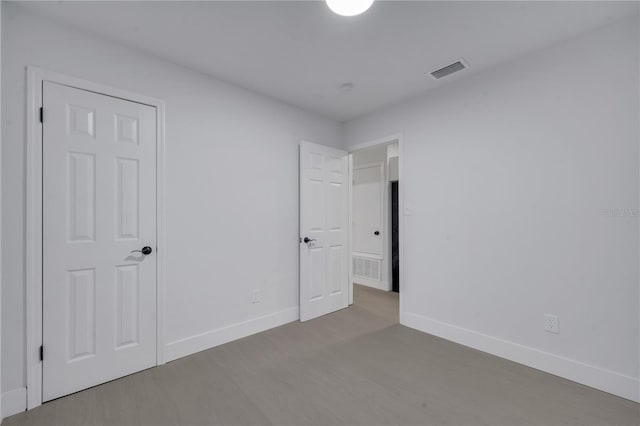 unfurnished bedroom with hardwood / wood-style floors