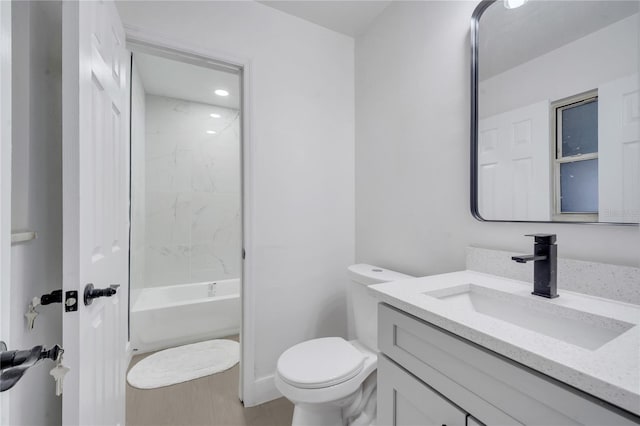 full bathroom featuring vanity, bathtub / shower combination, and toilet