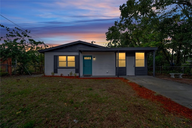 ranch-style home featuring a lawn