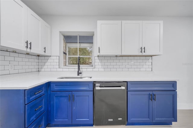 kitchen with white cabinetry, dishwasher, and sink