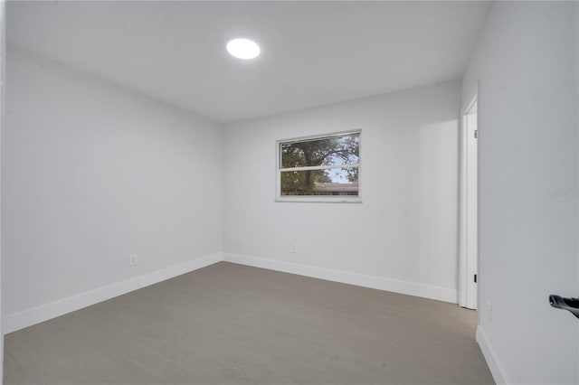 spare room featuring dark hardwood / wood-style floors