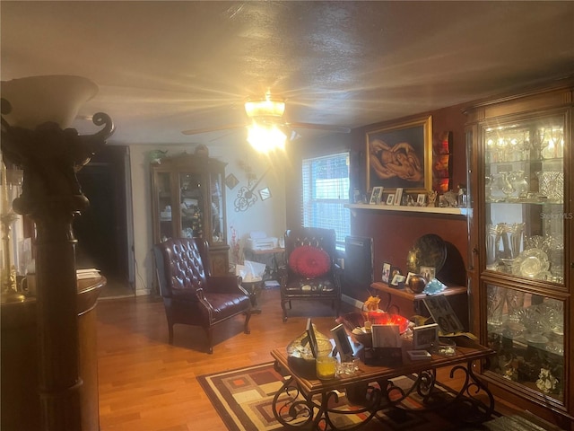 living room with wood-type flooring and ceiling fan