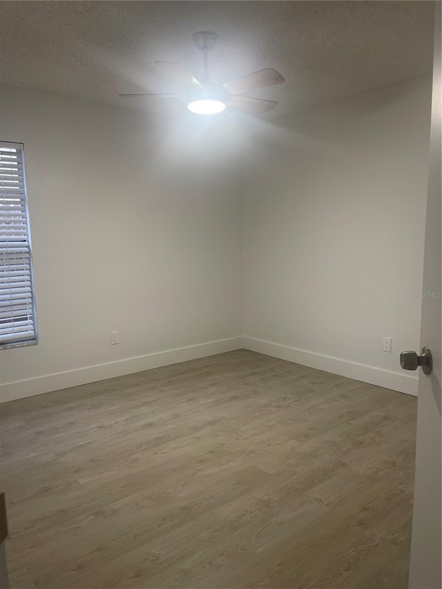 spare room with wood-type flooring and a textured ceiling