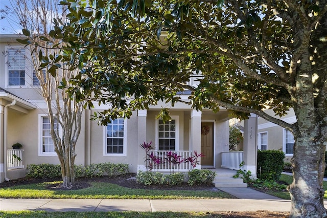 view of front facade featuring stucco siding and a porch