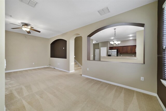 spare room featuring light carpet, visible vents, and baseboards