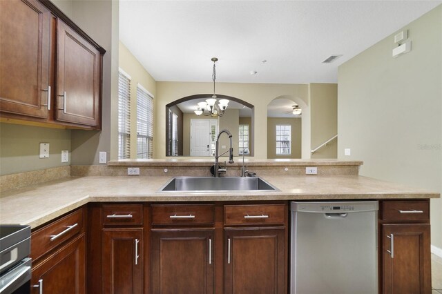 kitchen with visible vents, a sink, stainless steel dishwasher, arched walkways, and a healthy amount of sunlight