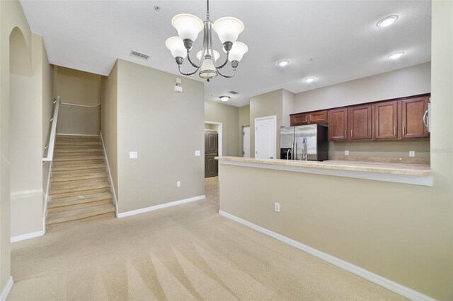 kitchen featuring visible vents, baseboards, light countertops, light carpet, and stainless steel appliances