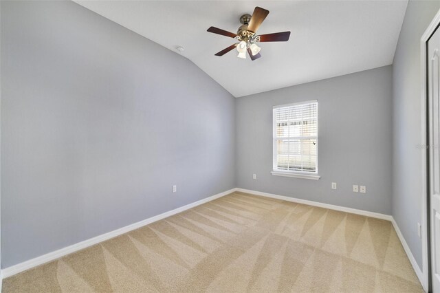 spare room featuring lofted ceiling, a ceiling fan, baseboards, and carpet floors