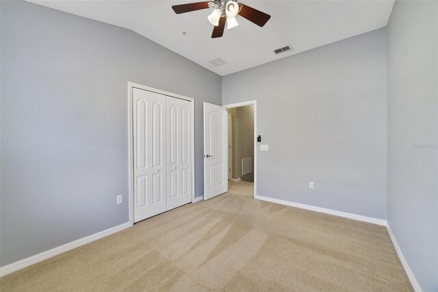 unfurnished bedroom with vaulted ceiling, baseboards, visible vents, and carpet floors