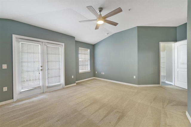 unfurnished bedroom featuring lofted ceiling, a ceiling fan, carpet floors, baseboards, and access to exterior