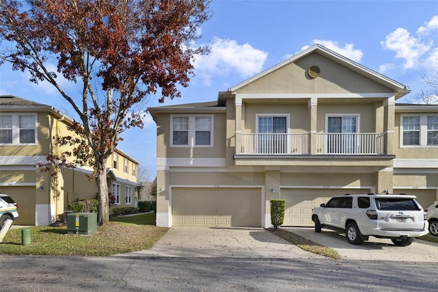 multi unit property featuring cooling unit, stucco siding, driveway, and an attached garage