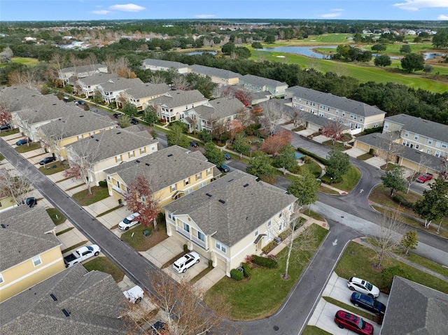 drone / aerial view featuring a residential view and a water view