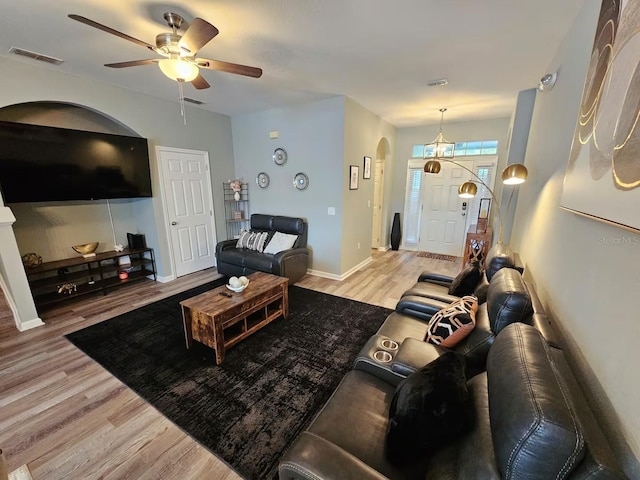 living room with light wood-type flooring and ceiling fan