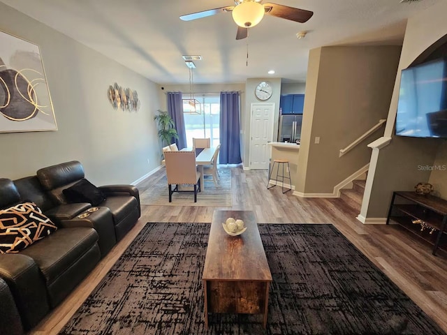 living room featuring ceiling fan and light hardwood / wood-style floors