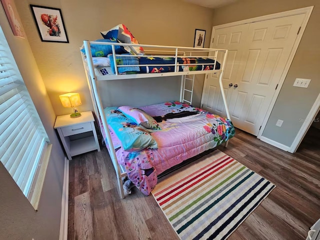 bedroom with a closet and dark wood-type flooring