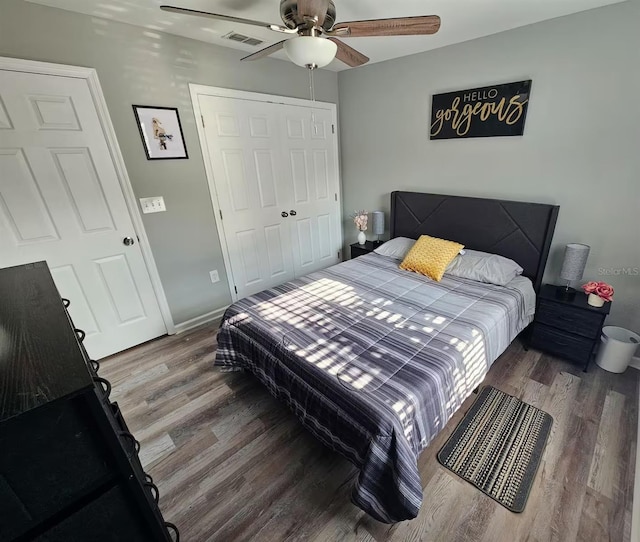 bedroom with hardwood / wood-style floors, ceiling fan, and a closet