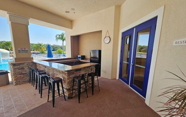 view of patio featuring an outdoor bar