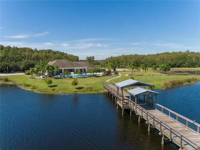 dock area with a water view and a yard