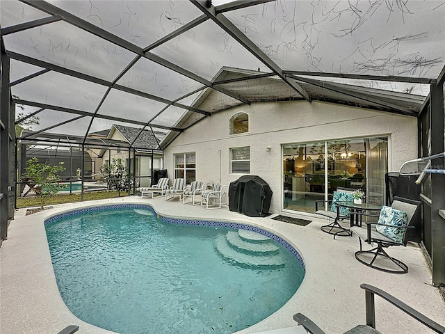 view of pool featuring a patio area, a lanai, and a grill