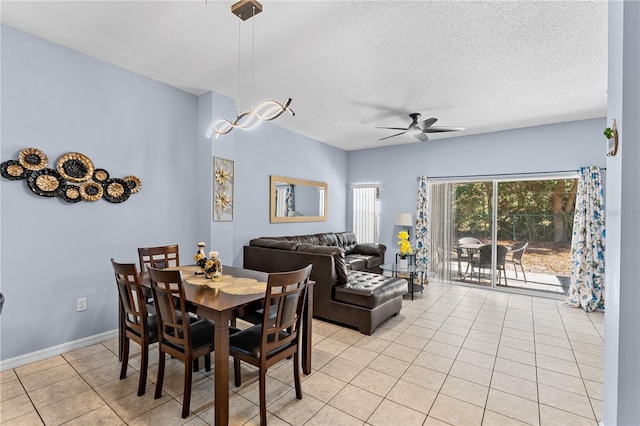 dining room with light tile patterned floors, a textured ceiling, and ceiling fan