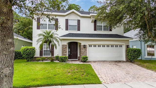 view of front of home with a front lawn and a garage