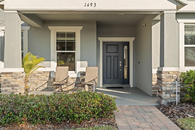 view of exterior entry with a porch