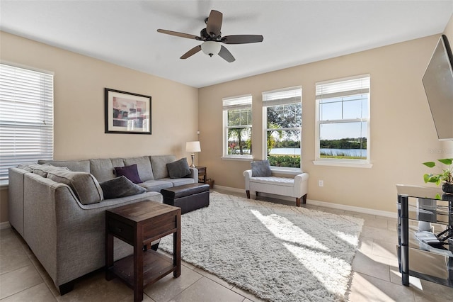 tiled living room featuring ceiling fan and a wealth of natural light