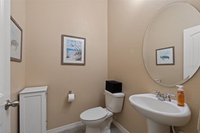 bathroom featuring toilet and sink