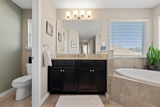 bathroom featuring toilet, vanity, tile patterned flooring, a relaxing tiled tub, and a chandelier