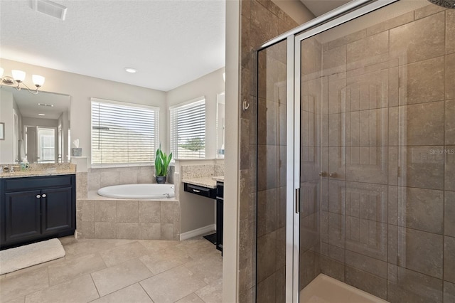 bathroom with plus walk in shower, tile patterned flooring, a textured ceiling, and vanity