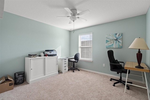 carpeted office with ceiling fan and a textured ceiling