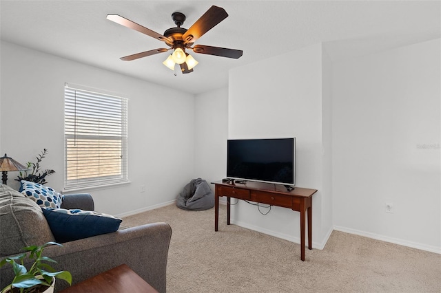 carpeted living room featuring ceiling fan