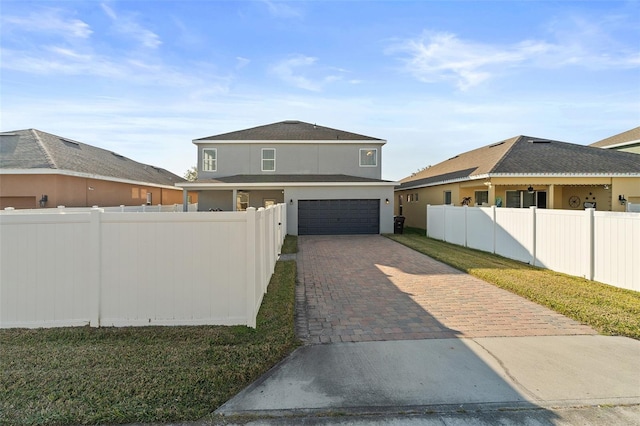 view of front facade featuring a garage and a front lawn