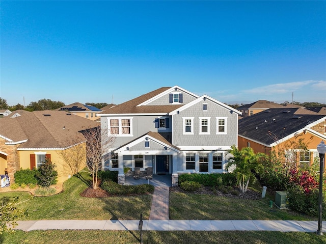 view of front of house featuring a front yard and a patio