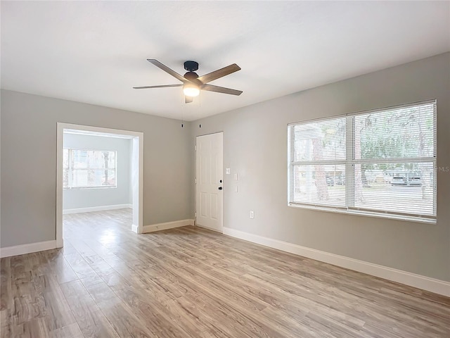 empty room with ceiling fan and light wood-type flooring