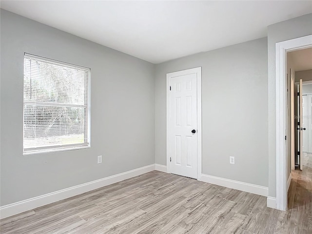 unfurnished room with light hardwood / wood-style floors