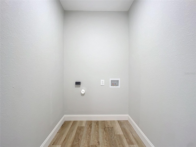 washroom featuring hookup for a washing machine and light wood-type flooring