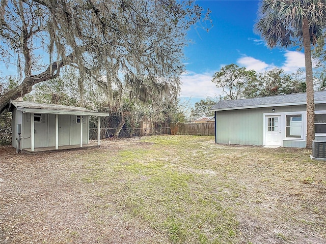 view of yard featuring cooling unit and a storage shed