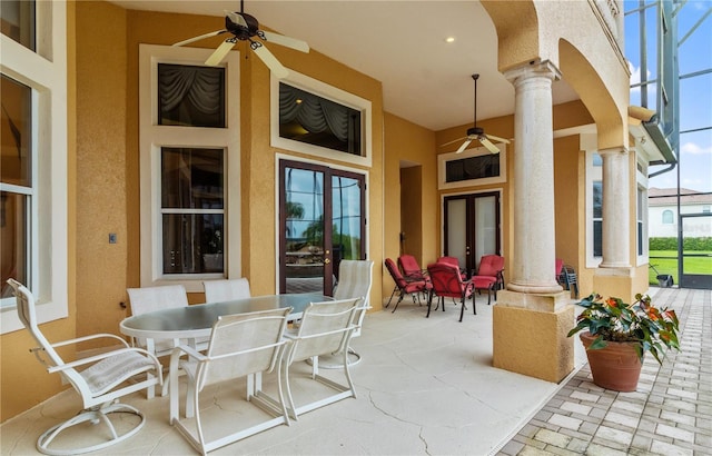 view of patio / terrace with ceiling fan and glass enclosure