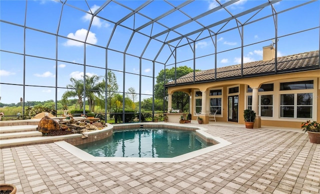 view of swimming pool featuring a lanai and a patio area