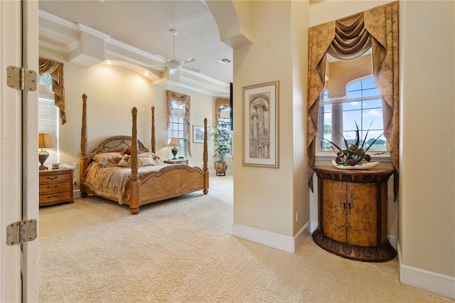 bedroom with multiple windows, ornamental molding, and carpet