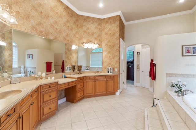 bathroom featuring tiled bath, tile patterned flooring, ornamental molding, and vanity