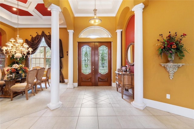 tiled entrance foyer featuring french doors, a notable chandelier, ornate columns, crown molding, and coffered ceiling