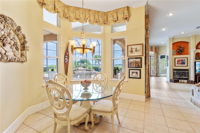 dining space with a high ceiling, light tile patterned floors, and a chandelier