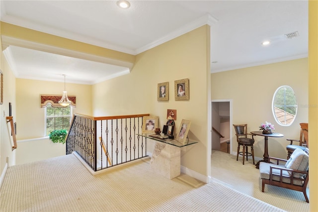 hallway with ornamental molding and carpet