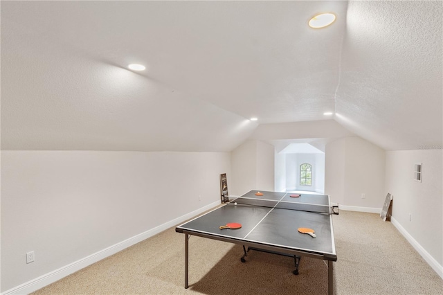 game room featuring lofted ceiling, a textured ceiling, and carpet