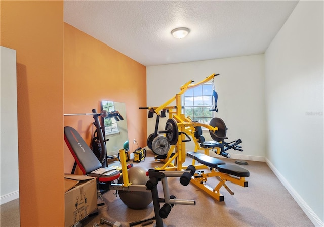 exercise room featuring a textured ceiling